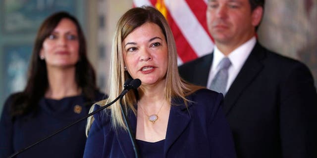 Judge Barbara Lagoa, center, speaks as Florida Gov. Ron DeSantis and Lt. Gov Jeanette Nunez, left, look on, Jan. 9, 2019, in Miami. (Associated Press)