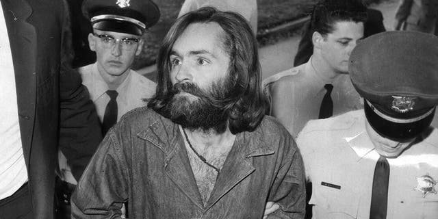 Charles Manson is escorted to court on Dec. 3, 1969, in Los Angeles, California.