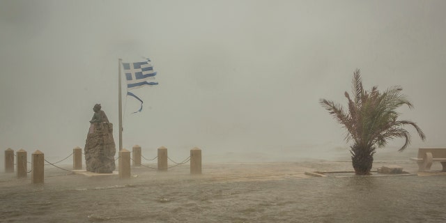 Seawater from crashing waves cover a road at the port of Argostoli, on the Ionian island of Kefalonia, western Greece, Friday, Sept. 18, 2020.