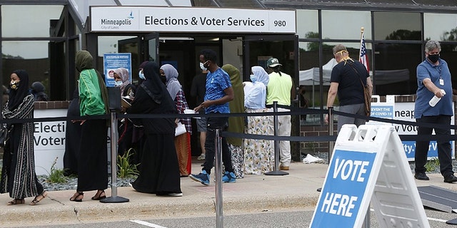 Minneapolis voters line up a day ahead of Minnesota's primary election in early August. (AP Photo/Jim Mone)