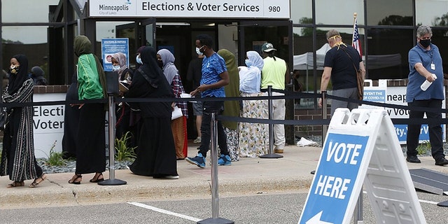 Minneapolis voters line up a day ahead of Minnesota's primary election in early August. (AP Photo/Jim Mone)