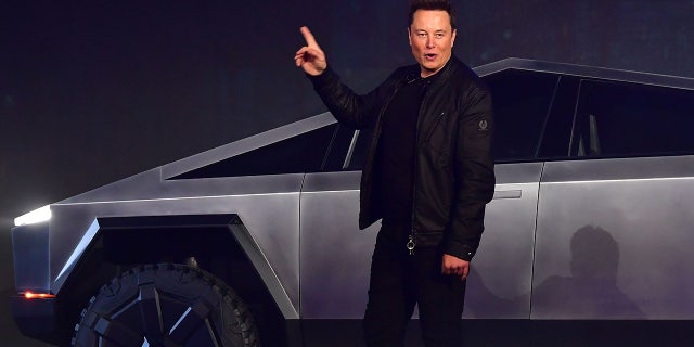 Tesla co-founder and CEO Elon Musk gestures while introducing the newly unveiled all-electric battery-powered Tesla Cybertruck at Tesla Design Center in Hawthorne, California on November 21, 2019. (Photo by Frederic J. BROWN / AFP)