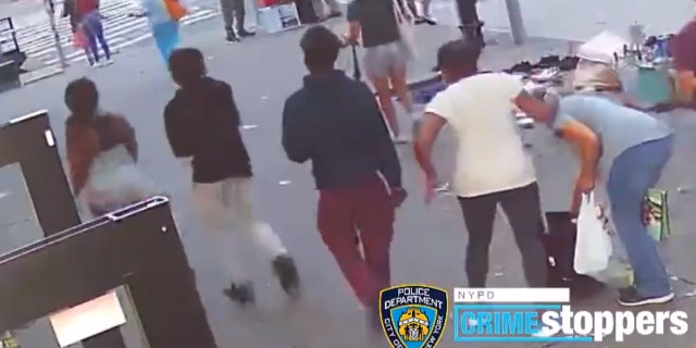 A 74-year-old woman (wearing a white shirt) confronts a group of teenagers after her purse was stolen before she was punched in the face on Thursday.