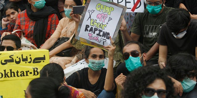 Members of civil society groups take part in a rally to condemn the incident of rape on a deserted highway, in Karachi, Pakistan, Saturday, Sept. 12, 2020. Pakistani police said they detained 15 people for questioning after two armed men allegedly gang-raped a woman in front of her children after her car broke down on a deserted highway near the eastern city of Lahore. (AP Photo/Fareed Khan)