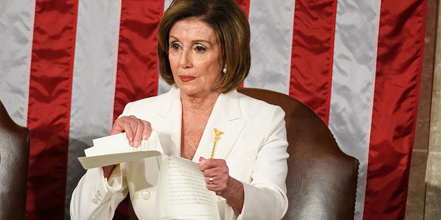 Speaker of the US House of Representatives Nancy Pelosi rips a copy of US President Donald Trump's speech after he delivers the State of the Union address at the US Capitol in Washington, DC, on February 4, 2020. (Photo by MANDEL NGAN / AFP) (Photo by MANDEL NGAN/AFP via Getty Images)