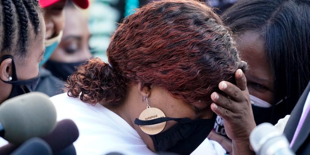 Tamika Palmer, the mother of Breonna Taylor, center, listens to a news conference, in Louisville, Ky., on Friday. (AP)