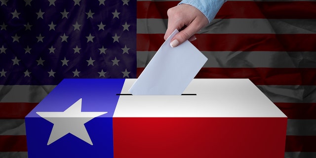 A hand casting a vote in a ballot box for an election in the Texas, USA