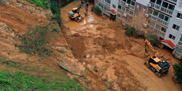 Mud from a landslide hit a parking lot at an apartment in Geoje, South Korea, Monday, Sept. 7, 2020.