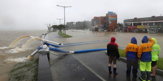 Officials from Gangneung city pump out water from a flooded area due to heavy rain in Gangneung, South Korea, Monday, Sept. 7, 2020.