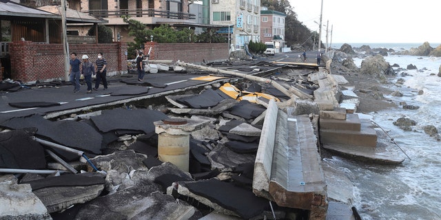 A coastal road is damaged in Ulsan, South Korea, Monday, Sept. 7, 2020.