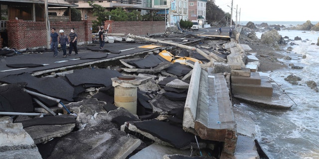 A coastal road is damaged in Ulsan, South Korea, Monday, Sept. 7, 2020.