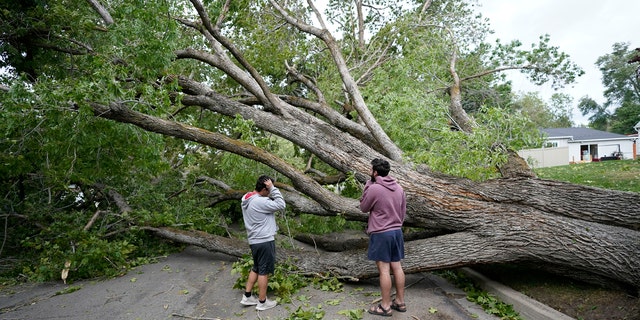 People survey the damage after high winds caused widespread damage and power outages Tuesday, Sept. 8, 2020, in Salt Lake City.