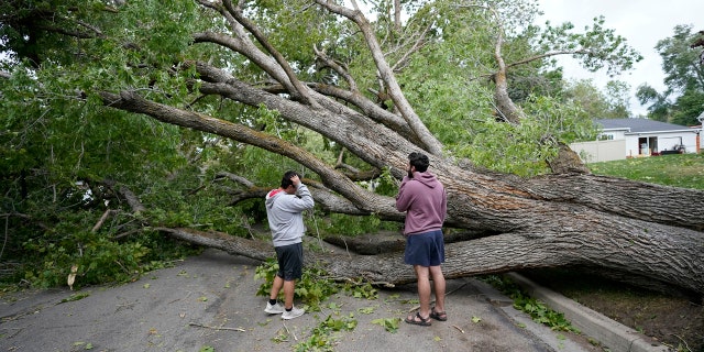 People survey the damage after high winds caused widespread damage and power outages Tuesday, Sept. 8, 2020, in Salt Lake City.