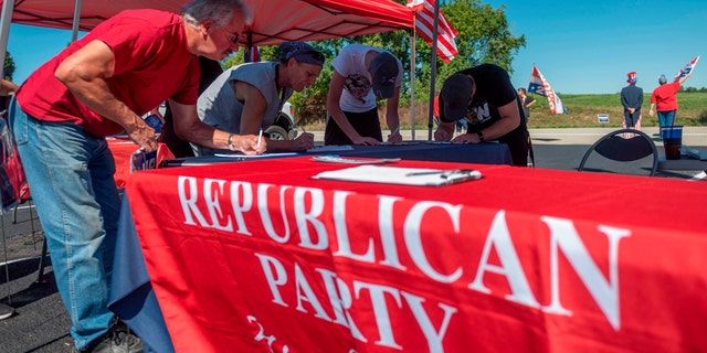 People register to vote during a GOP event in Brownsville, Pa., on Sept. 5, 2020. Less than two months before the Nov. 3 presidential election, the contrast between Republicans and Democrats is striking in Washington County, in the suburbs of Pittsburgh. (Photo by ANDREW CABALLERO-REYNOLDS/AFP via Getty Images)