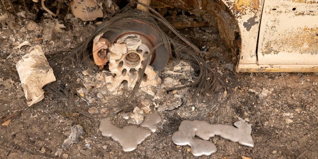 Flames from the Beachie Creek Fire melted the aluminum rims on a car near the destroyed Oregon Department of Forestry, North Cascade District Office in Lyons, Ore., Sunday, Sept. 13, 2020.