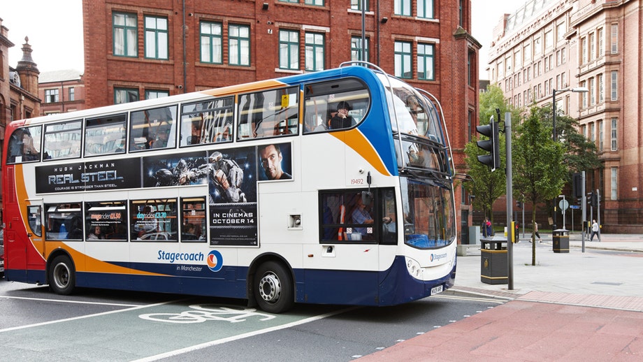 Man using live snake as face mask boards bus in England