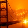 Embers light up a hillside behind the Bidwell Bar Bridge as the Bear Fire burns in Oroville, California, Sept. 9, 2020. 