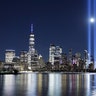 The moon rises between the beams of the Tribute in Light as it is tested over lower Manhattan and One World Trade Center in New York City, Sept. 4, 2020. 