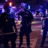 Police stand guard on the perimeter of a crime scene after a police officer was shot, Wednesday, Sept. 23, 2020, in Louisville, Ky. A grand jury has indicted one officer on criminal charges six months after Breonna Taylor was fatally shot by police in Kentucky.