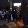 Protesters react to gunfire, Wednesday, Sept. 23, 2020, in Louisville, Ky. A police officer was shot in the evening. A grand jury has indicted one officer on criminal charges six months after Breonna Taylor was fatally shot by police in Kentucky.