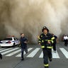 Policemen and firemen run away from the huge dust cloud caused as the World Trade Center's Tower One collapses after terrorists crashed two hijacked planes into the twin towers, Sept. 11, 2001 in New York City.