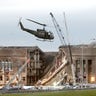 A military helicopter flies in front of the Pentagon Sept.m14, 2001 in Arlington, Virginia at the impact site where a hijacked airliner crashed into the building.