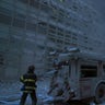 A New York firefighter amid the rubble of the World Trade Center following the 9/11 attacks. 