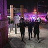 Protesters in Louisville, Ky., on Sept. 23, 2020, walk away from police with their hands up after two police officers were shot during a protest after a grand jury considering the March killing of Breonna Taylor, a Black medical worker, in her home in Louisville, voted to indict one of three White police officers for wanton endangerment.