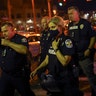 Robert Schroeder, interim chief of the Louisville Metro Police Department, puts on a face mask after a news conference in Louisville, Ky., Sep. 23, 2020, confirming two officers have been shot after protesters clashed with police after a grand jury considering the March killing of Breonna Taylor, a Black medical worker, in her home in Louisville, voted to indict one of three white police officers for wanton endangerment.