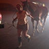 Jennifer Steckler walks two horses along state Highway 226 in Lyons, Ore., early Tuesday, Sept. 8, 2020. Steckler had walked them for more than two miles during evacuation from the Santiam Fire.