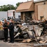 President Donald Trump tours an area Tuesday, Sept. 1, 2020, that was damaged during demonstrations after a police officer shot Jacob Blake in Kenosha, Wis. At left is Attorney General William Barr and acting Homeland Security Secretary Chad Wolf. (AP Photo/Evan Vucci)