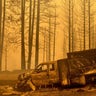 A scorched truck rests on Highway 168 after the Creek Fire burned through the area on Tuesday, Sept. 8, 2020, in Fresno County, Calif.