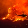 A helicopter prepares to drop water at a wildfire in Yucaipa, Calif., on Sept. 5, 2020. A couple’s plan to reveal their baby’s gender at a party went up in smoke Saturday at El Rancho Dorado Park in Yucaipa, when a pyrotechnical device they used sparked a wildfire that has burned thousands of acres.