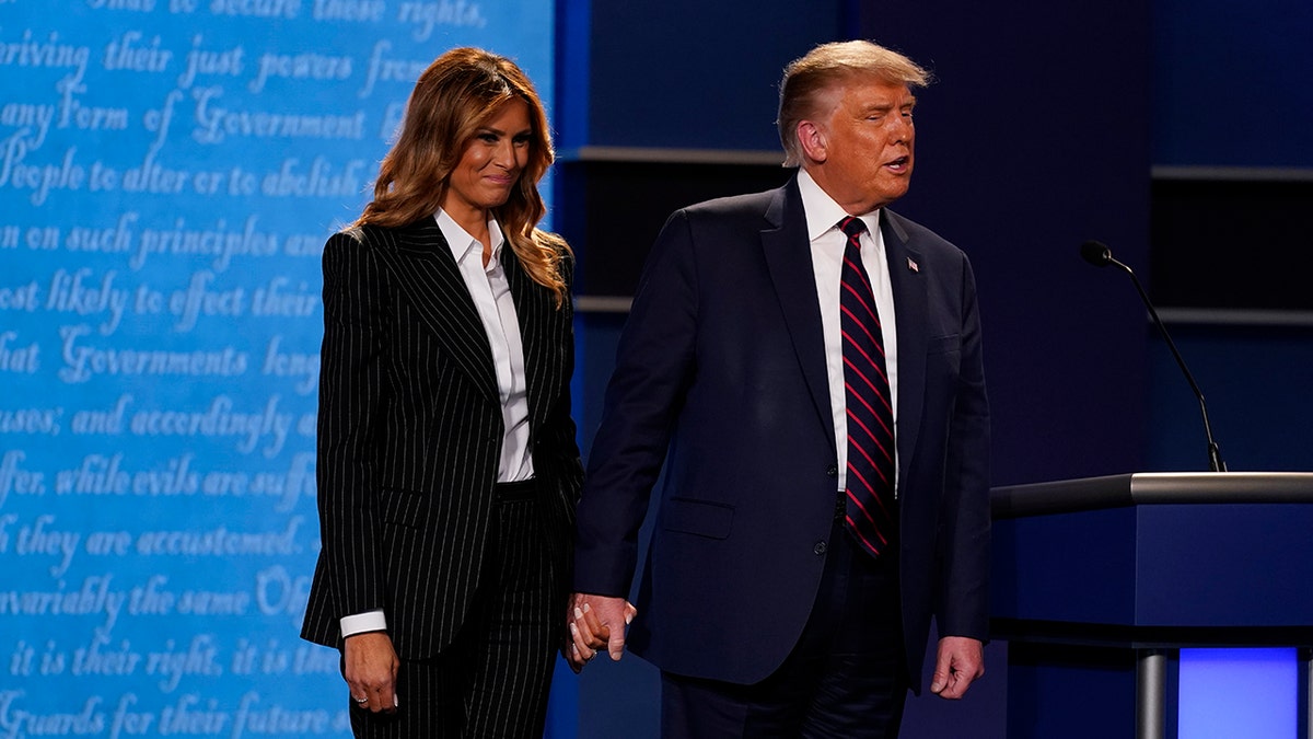 President Donald Trump and first lady Melania Trump on stage at the end of the first presidential debate Tuesday, Sept. 29, 2020, at Case Western University and Cleveland Clinic, in Cleveland, Ohio. (AP Photo/Patrick Semansky)