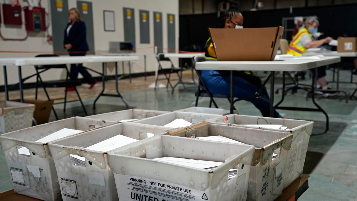 In this Sept. 3, 2020, file photo, workers prepare absentee ballots for mailing at the Wake County Board of Elections in Raleigh, N.C. (AP Photo/Gerry Broome)