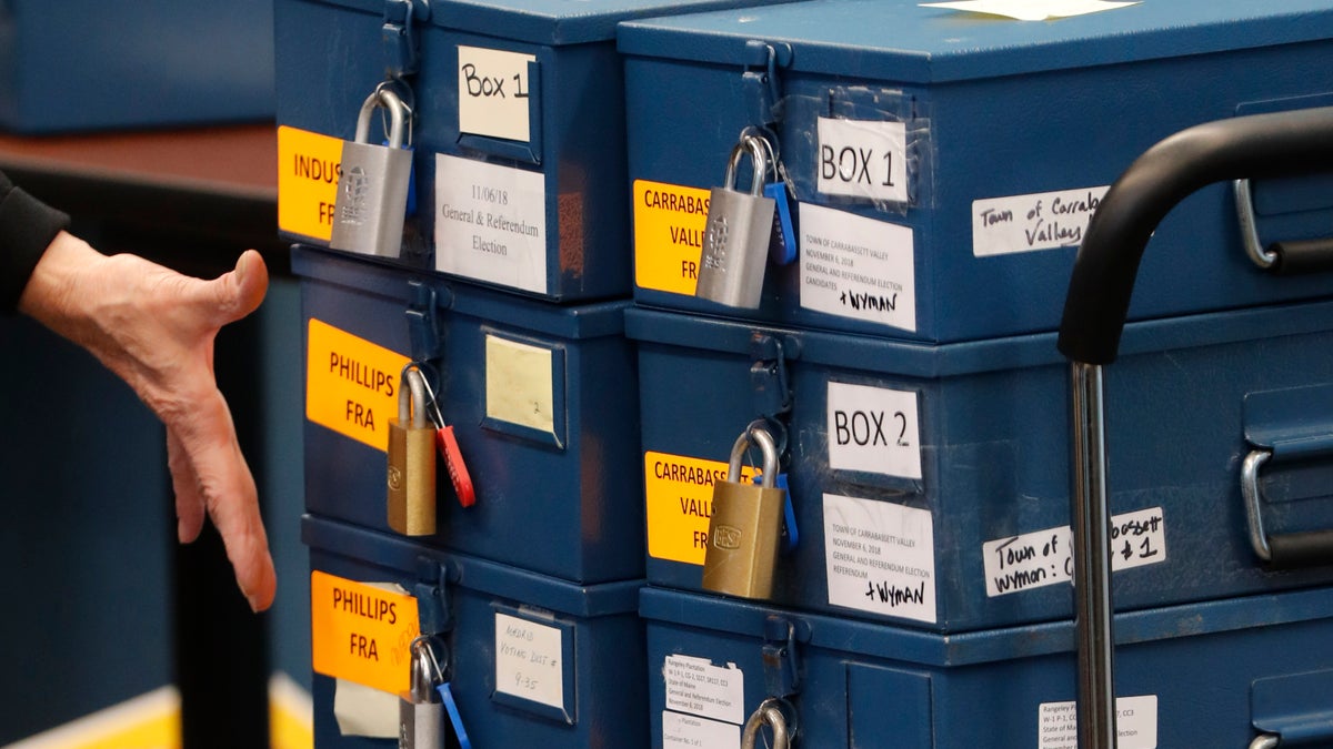 FILE - In this Nov. 12, 2018 file photo, ballot boxes are brought into for a ranked choice voting tabulation in Augusta, Maine. The state's supreme court is hearing more arguments from the Maine GOP, which is seeking to appeal to the U.S. Supreme Court to prevent ranked choice voting from being used in the presidential contest. (AOP Photo/Robert F. Bukaty, File)