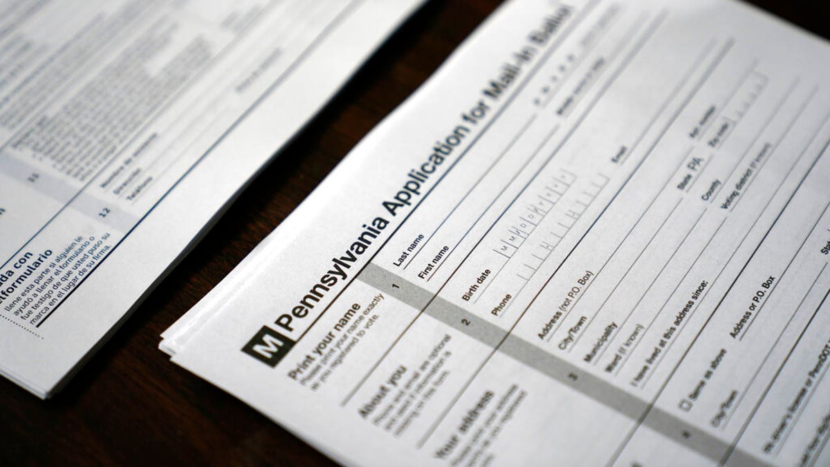 FILE: Applications for mail-in ballots are seen at a satellite election office at Temple University's Liacouras Center in Philadelphia.