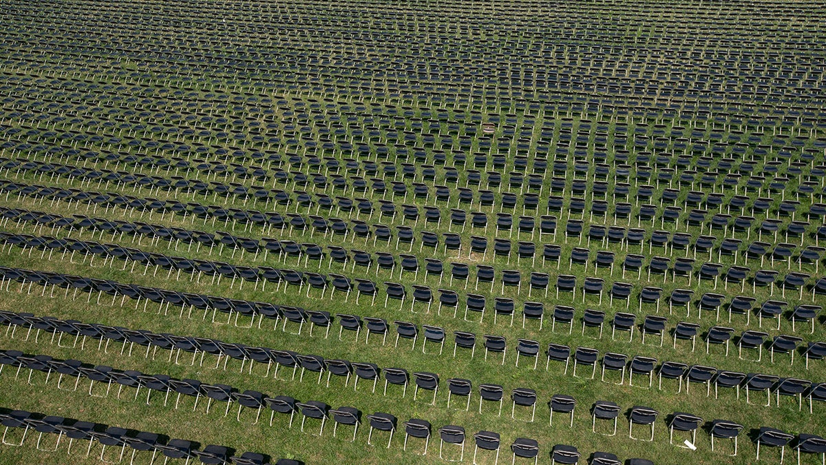 The empty chairs represent a fraction of the more than 200,000 lives lost due the COVID-19 are seen during the National COVID-19 Remembrance, at The Ellipse outside of the White House, Sunday, Oct. 4, 2020, in Washington. (AP Photo/Jose Luis Magana)