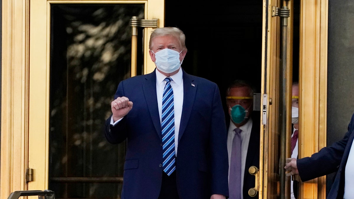 President Donald Trump walks out of Walter Reed National Military Medical Center to return to the White House after receiving treatments for COVID-19, Monday, Oct. 5, 2020, in Bethesda, Md. (AP Photo/Evan Vucci)