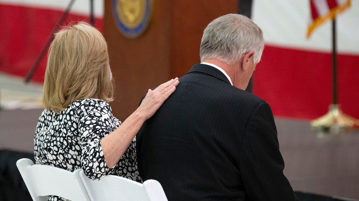 Parents Marsha and Carl Mueller listen during a ceremony to unveil a painting honoring Kayla Mueller. (Rob Schumacher/The Arizona Republic via AP)