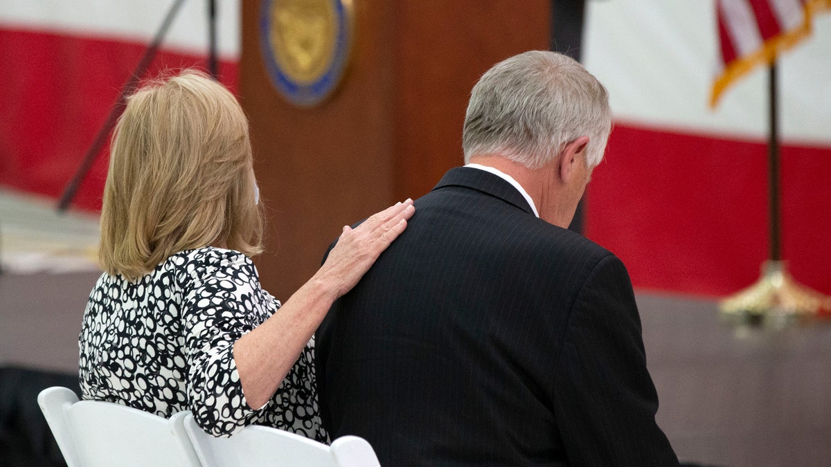 Parents Marsha and Carl Mueller listen during a ceremony to unveil a painting honoring Kayla Mueller. (Rob Schumacher/The Arizona Republic via AP)