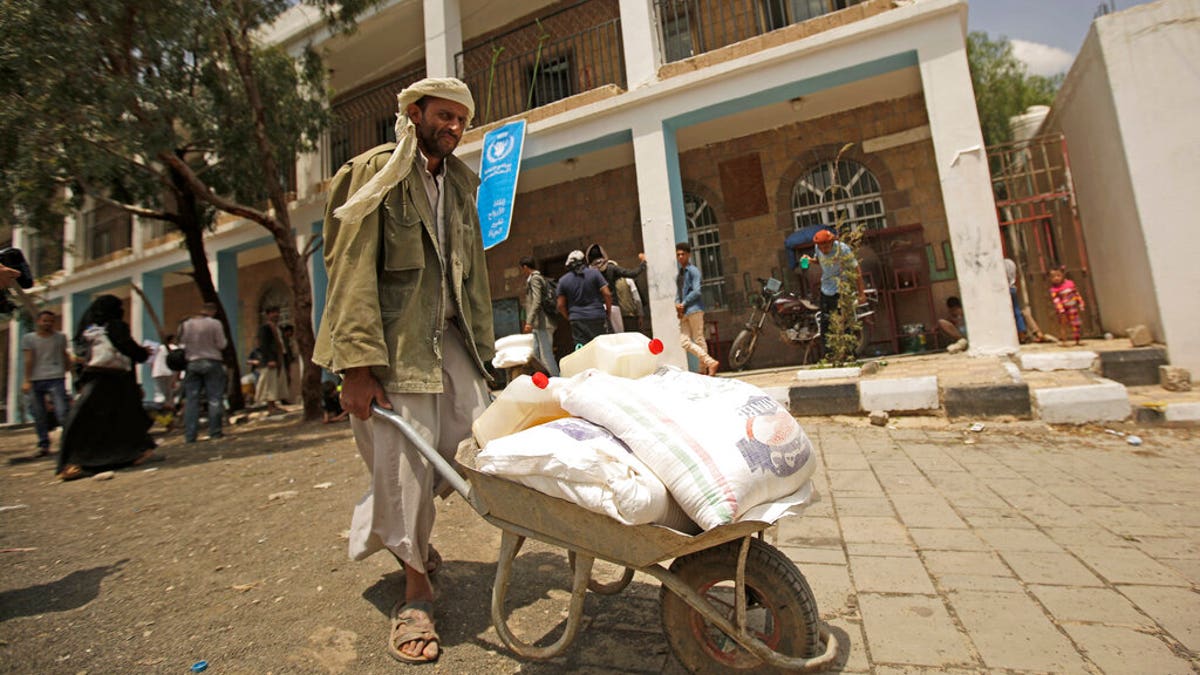 FILE: A displaced Yemeni receives food aid provided by the World Food Program, at a school in Sanaa, Yemen.