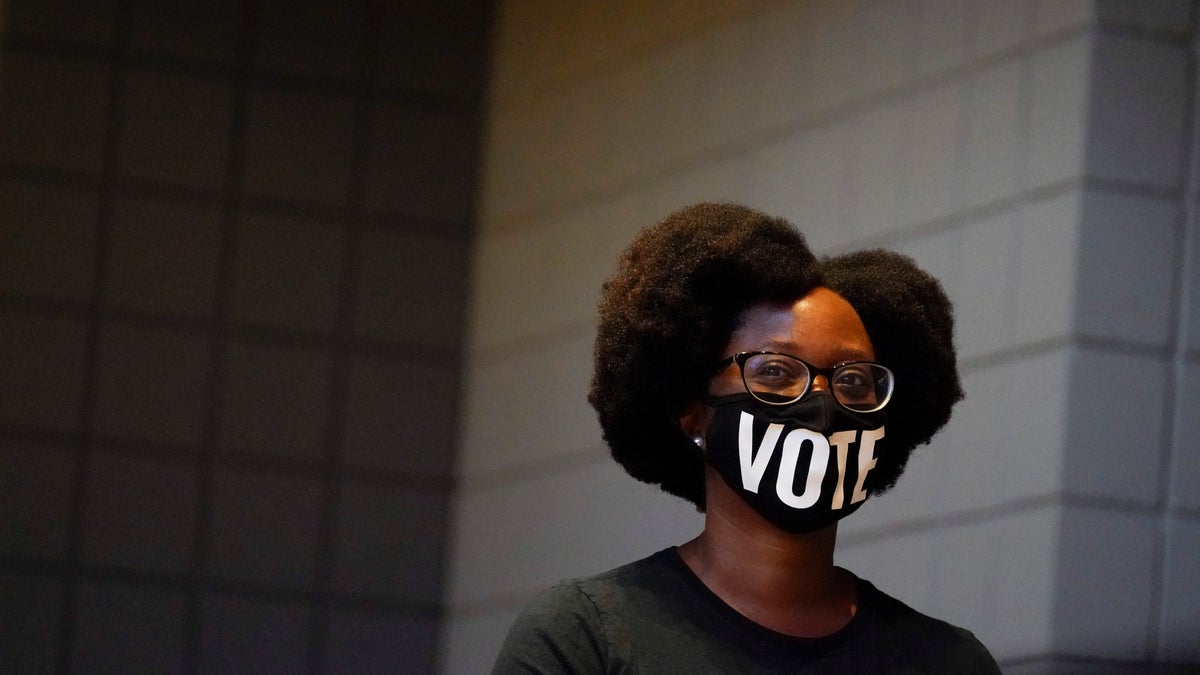 Ashley Nealy of Atlanta waits in a line to vote early at the State Farm Arena on Monday, Oct. 12, 2020, in Atlanta. (AP Photo/Brynn Anderson)
