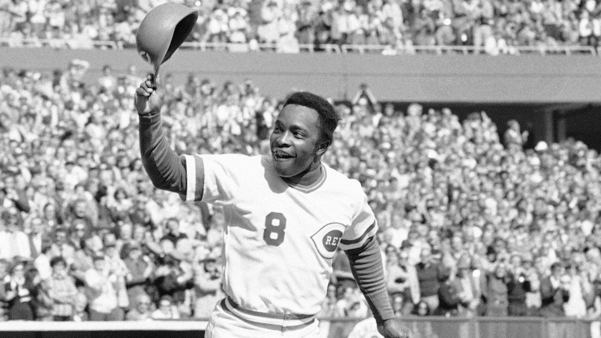 In this Saturday, Oct. 16, 1976, file photo, Cincinnati second baseman Joe Morgan tips his helmet to the fans as he rounds the bases after a homer in the first inning against the New York Yankees at Riverfront Stadium in Cincinnati. (AP Photo/File)