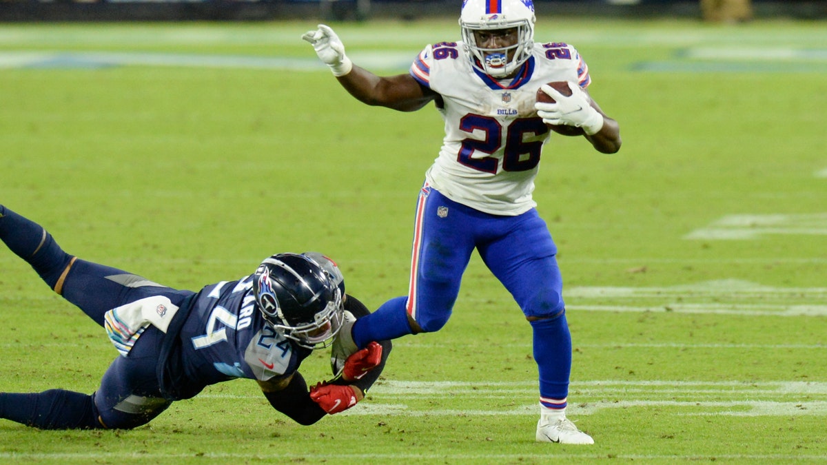 Buffalo Bills running back Devin Singletary (26) gets away from Tennessee Titans strong safety Kenny Vaccaro (24) in the second half of an NFL football game Tuesday, Oct. 13, 2020, in Nashville, Tenn. (AP Photo/Mark Zaleski)
