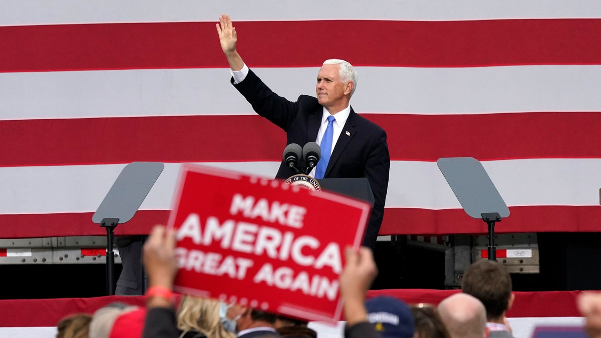 Vice President Mike Pence waves after speaking at a campaign rally, Wednesday, Oct. 14, 2020, in Grand Rapids, Mich. (Carlos Osorio)