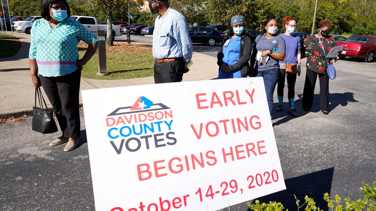 People wait to vote outside the Bordeaux Library on the first day of Tennessee's early voting Wednesday, Oct. 14, 2020, in Nashville, Tenn. (AP Photo/Mark Humphrey)