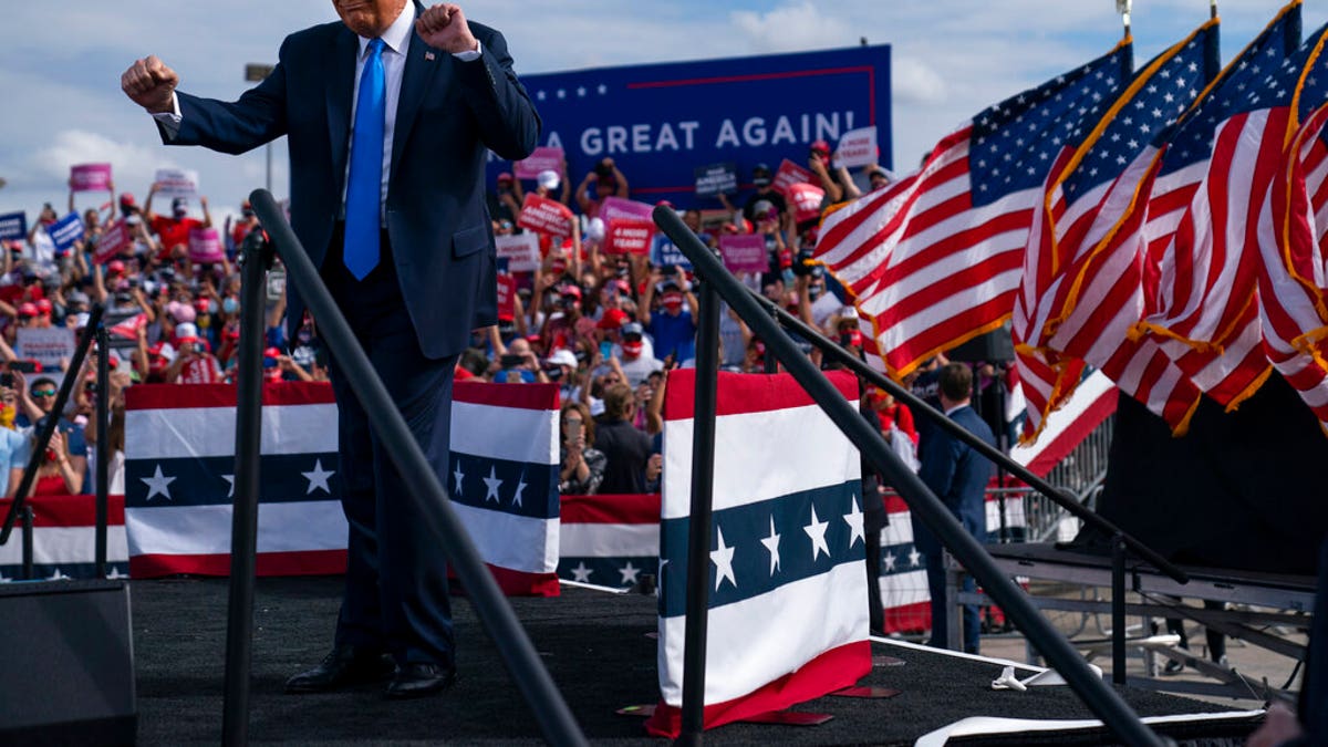 President Donald Trump dances as he walks off stage during a campaign rally at Pitt-Greenville Airport, Thursday, Oct. 15, 2020, in Greenville, N.C. (AP Photo/Evan Vucci)