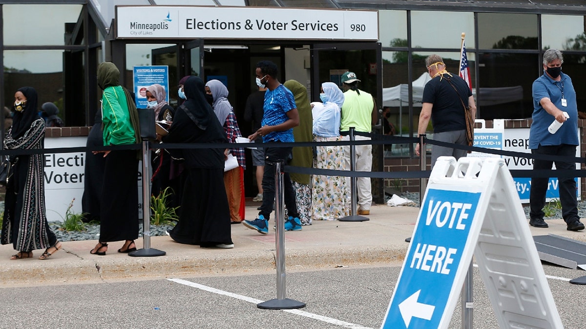 Minneapolis voters line up to vote a day ahead of Minnesota's Tuesday primary election at the Minneapolis Election and Voters Services offices. (AP Photo/Jim Mone, File)