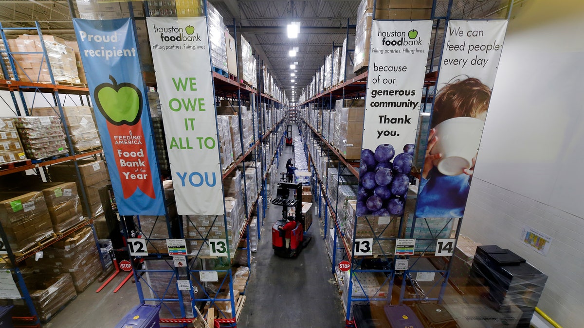 Pallets of various foods are stacked on shelves in the warehouse at the Houston Food Bank on Oct. 14. (AP Photo/Michael Wyke)